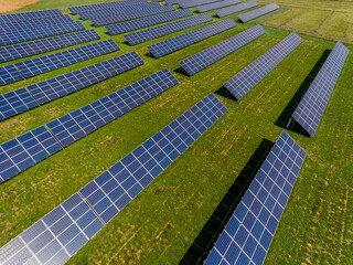 Photovoltaic farm - renewable energy from sunlight - photovoltaic panels set on a green field. Renewable energy supplying medium-sized enterprises