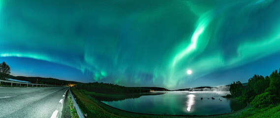 Panoramci Aurora borealis, Northern green lights with full moon and stars in the night sky over...