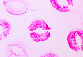 Pink female lip prints on white background. Kisses, smacks, lipstick prints and marks. Femininity,...