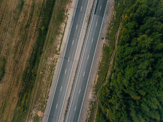 Fototapeta premium A view from above of an empty paved road in the countryside. 