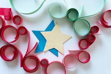 paper stars and swirls loops or curls on a light background