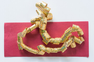 glittery ribbon partly on red paper