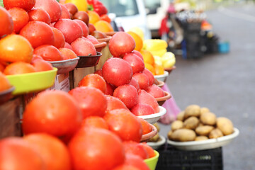 Tomatoes selling on local farm market, eco vegetables, juicy products. Shopping organic products. Healthy grocery
