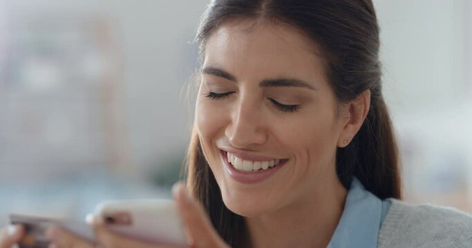 beautiful woman using smartphone shopping online spending money on credit card mobile banking app with digital currency enjoying financial freedom 4k