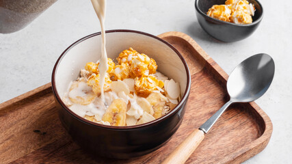 Bowl of cereal with pop corn and milk