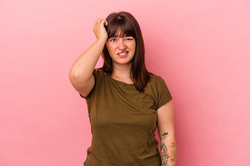 Young curvy caucasian woman isolated on pink background forgetting something, slapping forehead with palm and closing eyes.