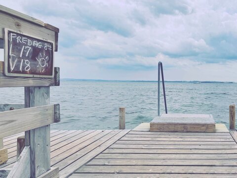 Bathing pier with daily air and water temperature readings on a blackboard, Egaa, Jutland, Denmark