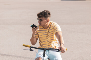 
young Latino riding a bmx bike in a field.
