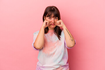 Young curvy caucasian woman isolated on pink background whining and crying disconsolately.