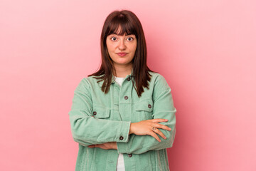 Fototapeta premium Young curvy caucasian woman isolated on pink background unhappy looking in camera with sarcastic expression.