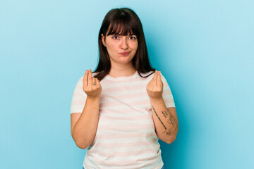 Fototapeta premium Young curvy caucasian woman isolated on blue background showing that she has no money.