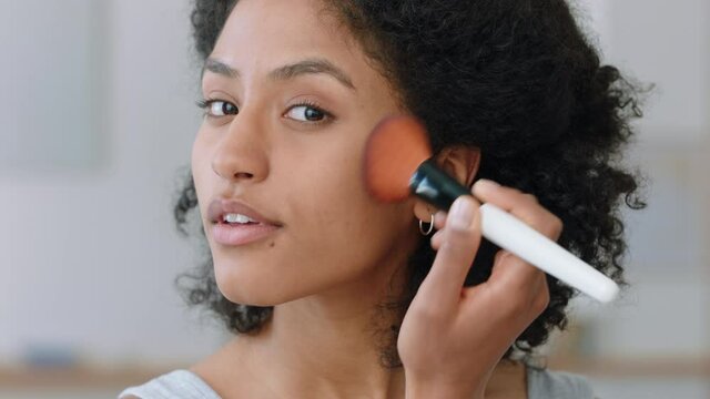 portrait beautiful mixed race woman applying makeup getting ready at home looking in mirror enjoying natural complexion feminine beauty 4k footage