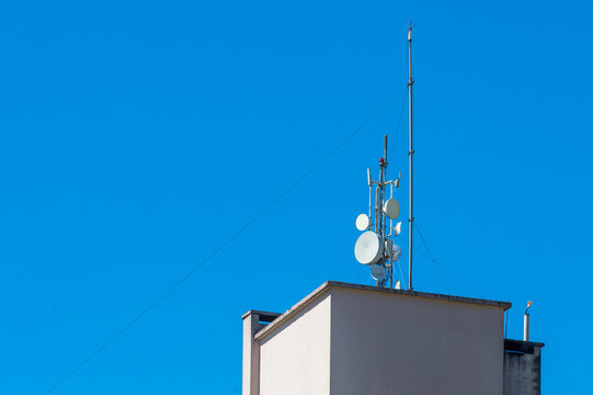 Building roof with lightning rods and antennas.