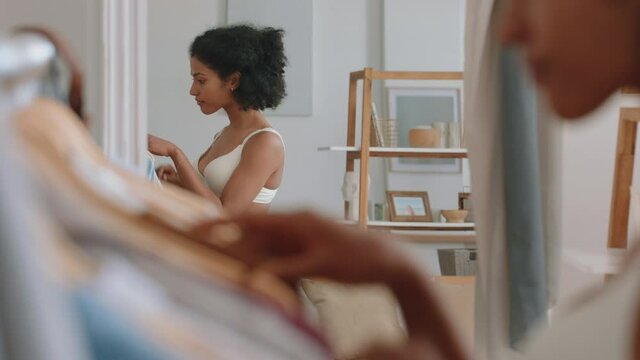 beautiful mixed race woman getting dressed looking in mirror fresh start to new day putting on clothes enjoying morning at home positive self image 4k footage