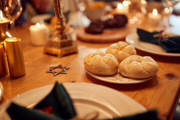 Close-up of dining table during Hanukkah celebration.