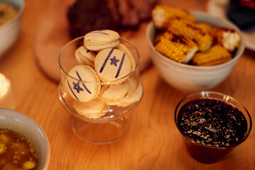 Close-up of cookies decorated with star of David on dining table during Hanukkah.