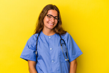 Young nurse woman isolated on yellow background  happy, smiling and cheerful.