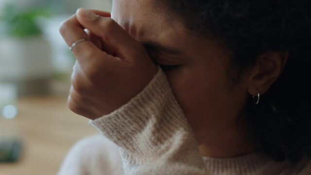 sad mixed race woman crying at home feeling unhappy over stressful break up stressed female upset over loss grieving relationship issues 4k footage depression concept