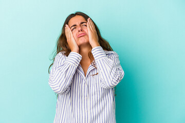 Young caucasian woman isolated on blue background  whining and crying disconsolately.