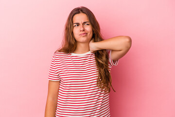 Young caucasian woman isolated on pink background  touching back of head, thinking and making a...
