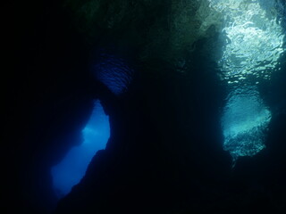cave scenery underwater exploring caves and having fun ocean scenery sun beams and rays background scuba divers to explore