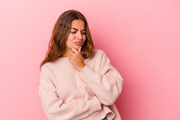 Young caucasian woman isolated on pink background  suffers pain in throat due a virus or infection.
