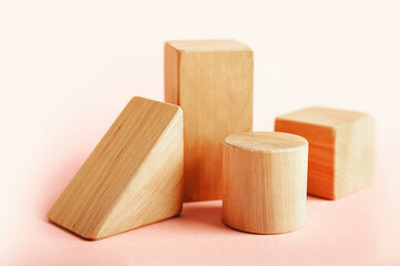 Wooden blocks podiums for goods on pink background. Geometric shapes for presentation of products, cosmetics...