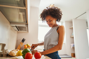 Attractive calm young woman making a salad