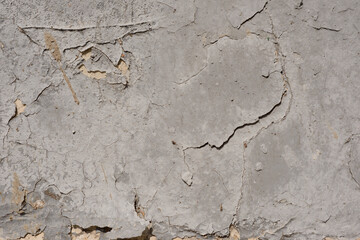 Old wall-  destroyed plaster. Grainy background- cracks, chips, peeling paint