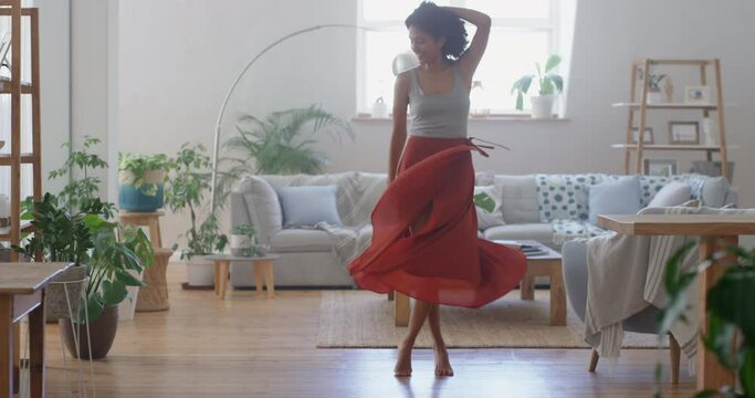 Happy African American Woman Dancing At Home Wearing Beautiful Red Dress Celebrating Having Fun Enjoying Summer Feeling Confident 4k Footage