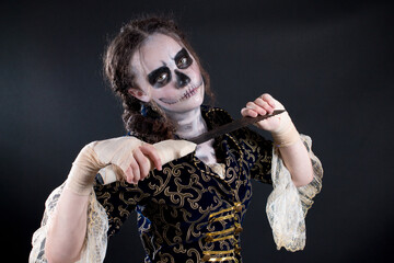 Young teenage girl dressed up for halloween as pirate ghost, wearing a victorian overcoat and lace