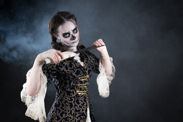 Young teenage girl dressed up for halloween as pirate ghost, wearing a victorian overcoat and lace