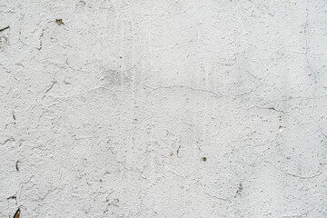 Texture of white painted wall, chipped, scratches. Stucco wall close-up