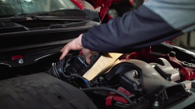 Replacing the car's air filter with a new one, maintenance, close-up