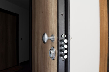 Apartment entrance door equipped with safe lock system and perfectly designed with wooden pattern.