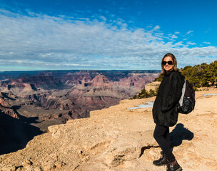 Female Hiker Admiring The Inner Canyon From The Rim Trail in Winter, South Rim, Grand Canyon National Park, Arizona, USA