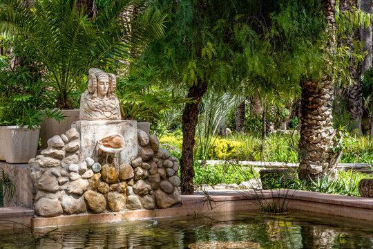 Lady of Elche in Elche's Huerto Del Cura botanical garden. Palm grove of Elche, Alicante, Spain.