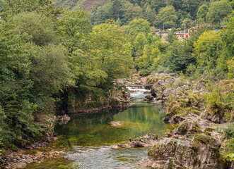 Fototapeta na wymiar Vistas del Río Sella, rodeado de vegetación , a su paso por el pueblo de Tornín en Cantabria, verano de 2020, España