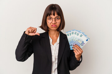 Young mixed race business woman holding a banknotes isolated on white background showing a dislike gesture, thumbs down. Disagreement concept.