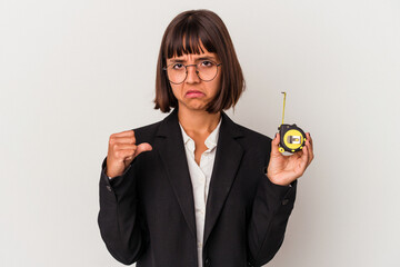 Young mixed race business woman holding a measure tape isolated on white background feels proud and self confident, example to follow.