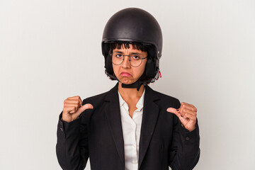 Young mixed race business woman wearing a motorbike helmet isolated feels proud and self confident, example to follow.