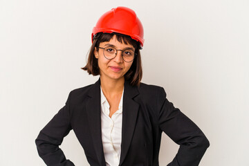 Young architect woman with red helmet isolated on white background confident keeping hands on hips.
