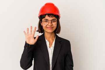 Young architect woman with red helmet isolated on white background smiling cheerful showing number five with fingers.