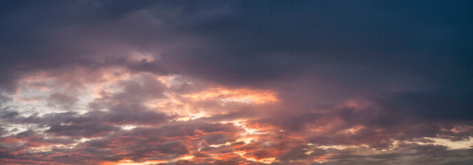 Purple cumulus clouds at sunset