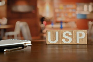 On a wood board, wooden word cubes are arranged in the letters USP. It is an abbreviation for...