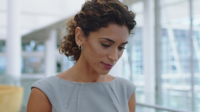 hispanic business woman using smartphone texting walking in corporate office typing text messages on mobile phone checking emails successful female executive at work 4k footage