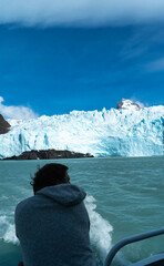 Big Iceberg, people looking at it from the boat, patagonia.