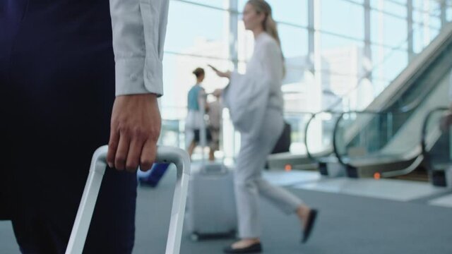 business woman traveler walking in airport with trolly bag going up escalator female executive traveling international for business trip checking messages on smartphone 4k