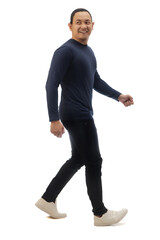 Asian man wearing casual dark blue shirt black denim and white shoes, walking forward and loooking back, side view, happy confidence expression. Full body portrait isolated
