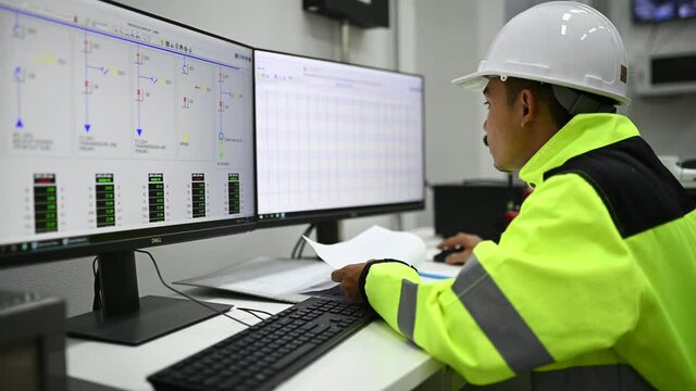 Electrical engineer man checking voltage at the Power Distribution Cabinet in the control room,preventive maintenance Yearly,Thailand Electrician working at company